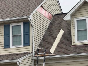 Damaged and aging vinyl siding on a home in Fredericksburg, VA before a professional replacement project.