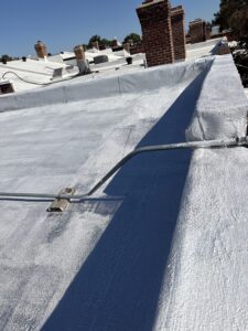 Completed flat roof coating on a low-slope roof by Weathertight Exteriors